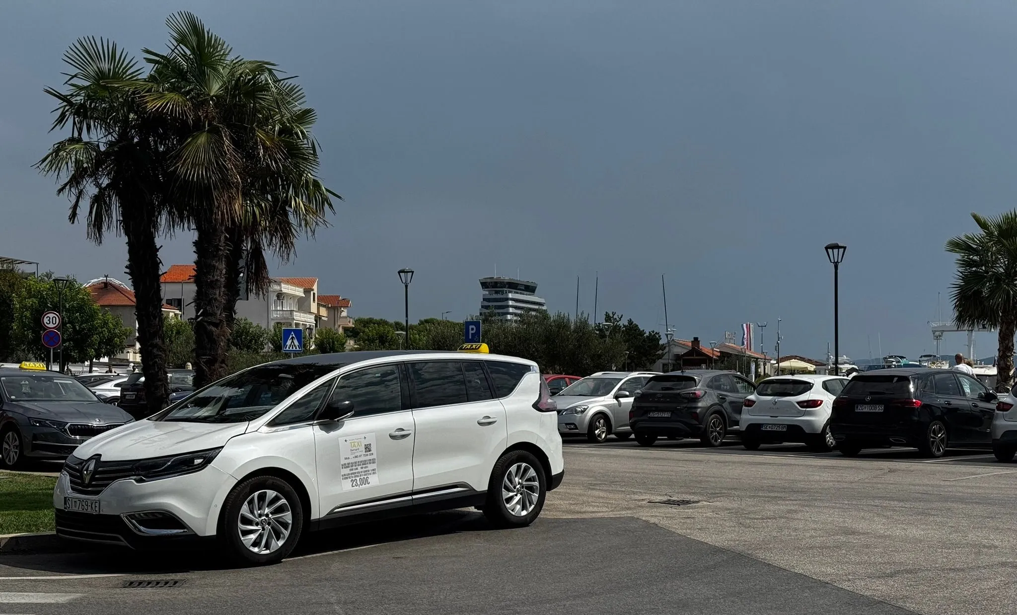 TAXI Bernard's Renault Espace parked at Vodice bus station under a palm tree